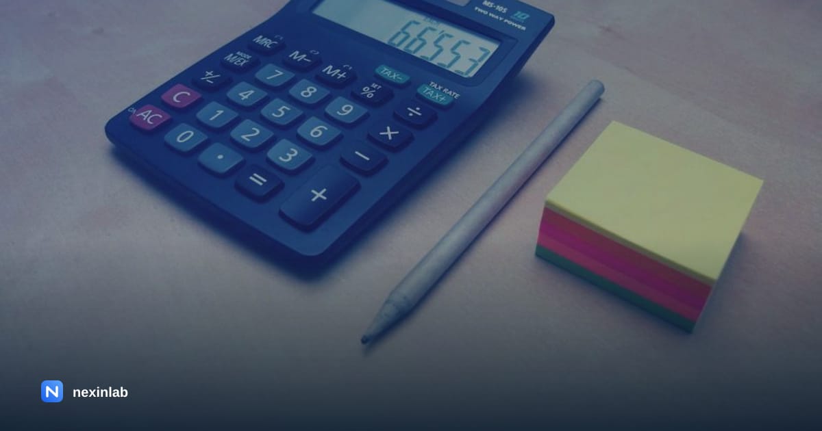 Photo: a calculator and sticky notes on a desk